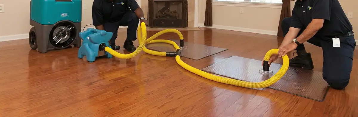 emergency water removal technicians extracting standing water from a home using professional equipment in Salt Lake City, UT